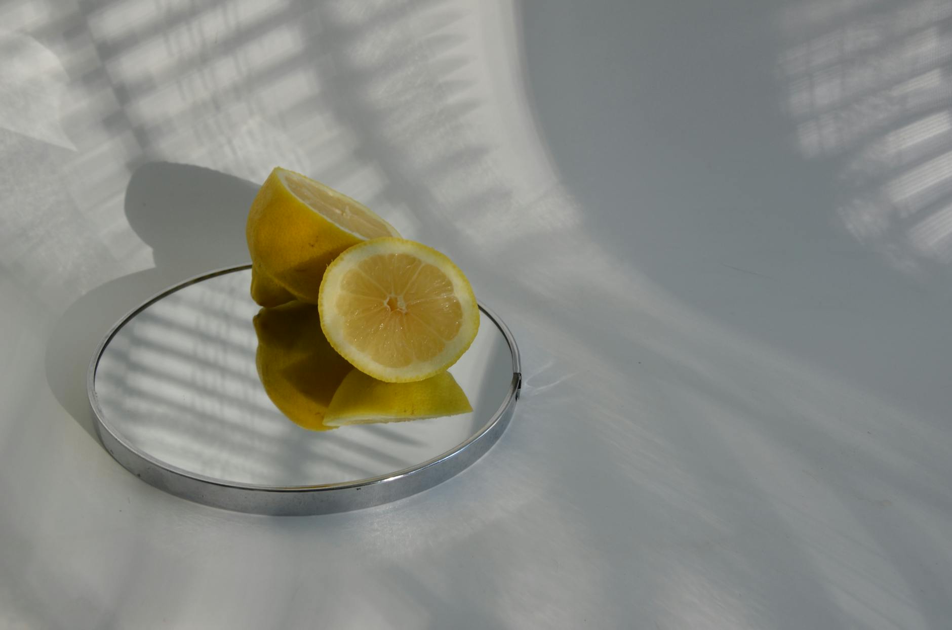 A hand holding a lemon vibrator against a minimalist backdrop, symbolizing intimacy during medication transitions.