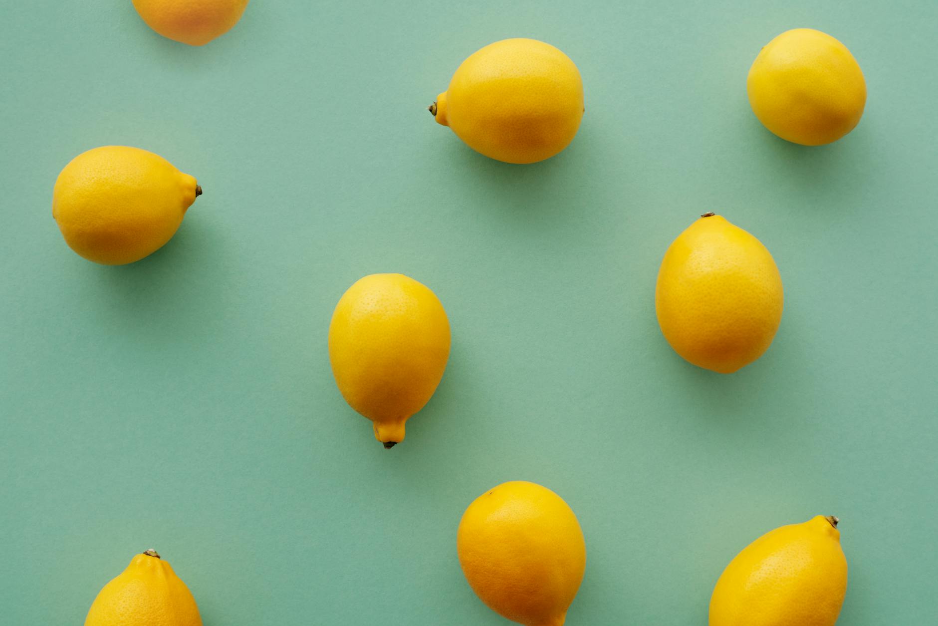 Bright yellow lemons arranged on a pastel surface, symbolizing the reawakening of sensation