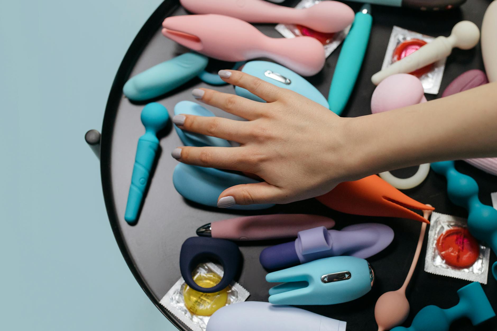 A collection of different colored vibrators and intimate wellness products arranged together