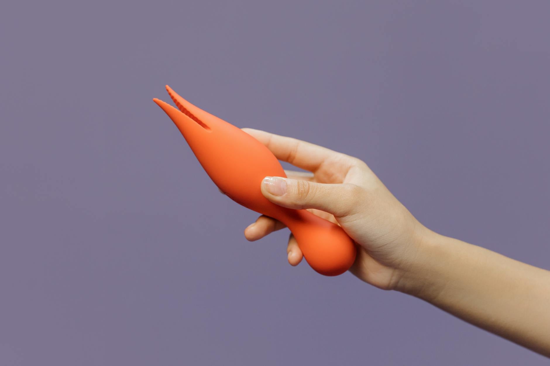 Collection of colorful clitoral vibrators and adult toys displayed on a bright yellow background