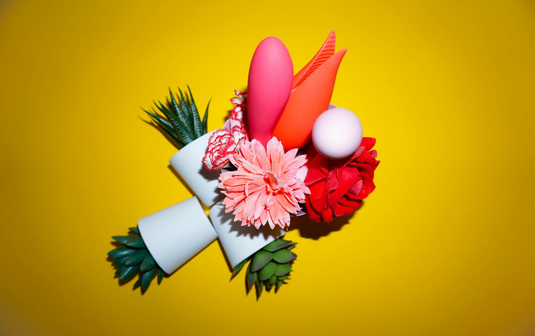 Hand holding a vibrator against a minimalistic backdrop, representing modern intimacy and reconnection